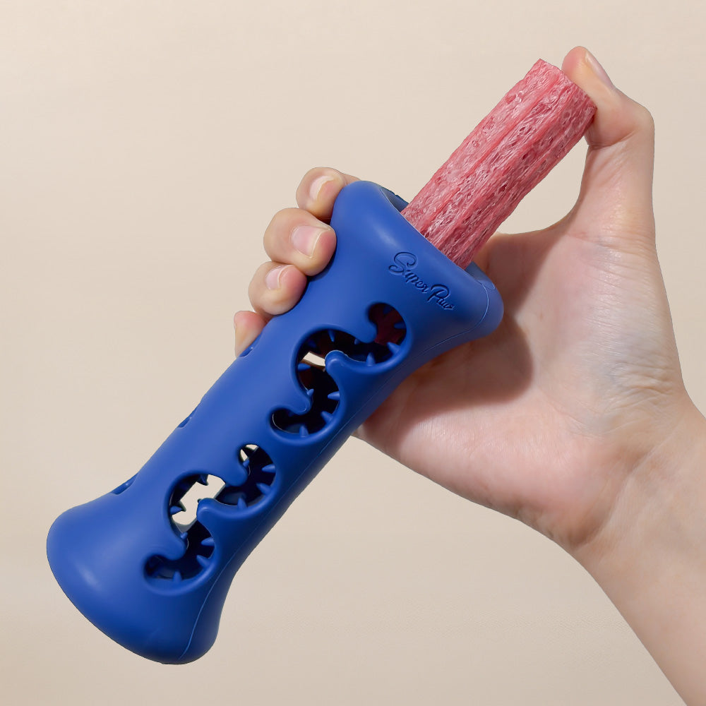 Hands inserting a Dental Chew into the blue Dental Chew Booster.